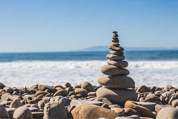 Wellness with Spinal Decompression as Balanced Rocks on a Beach